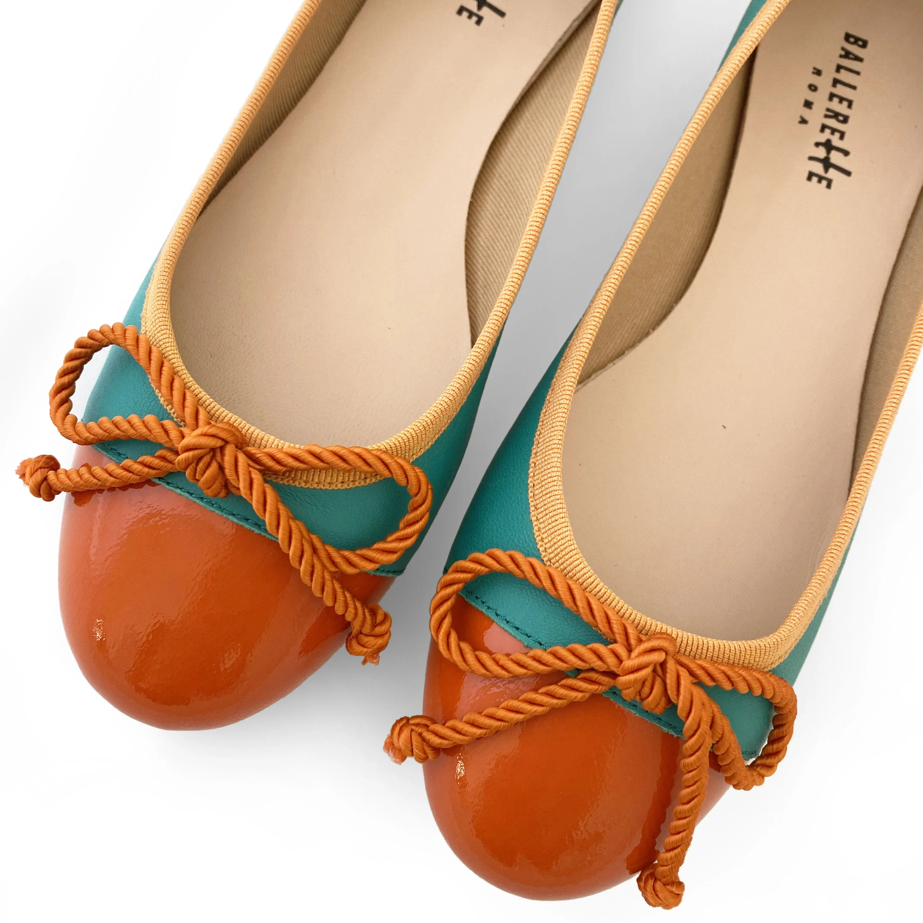 Teal leather ballet flats with orange toe and bow
